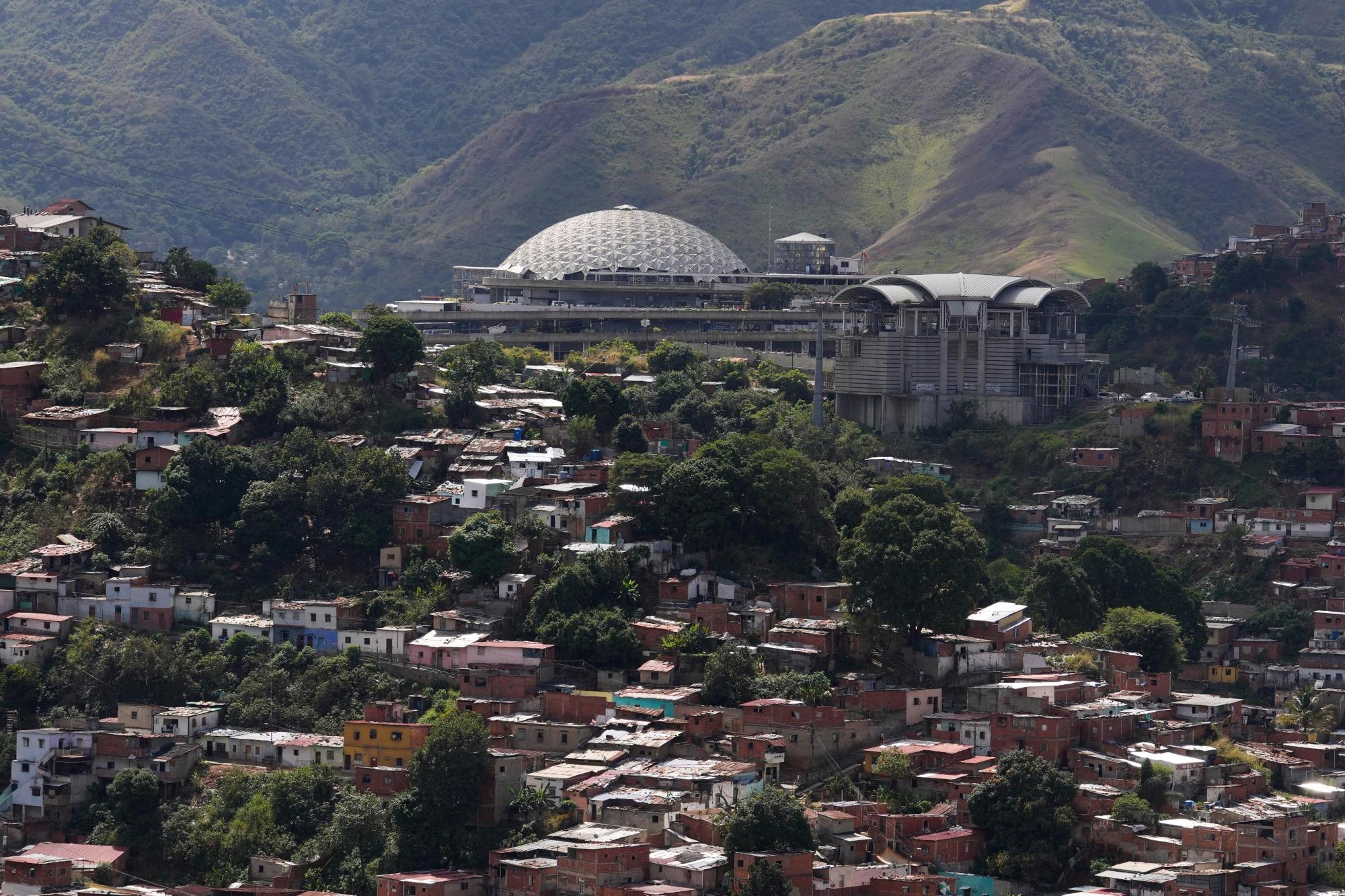 El Helicoide, top, the headquarters of Venezuela’s intelligence service and detention center, stands in Caracas, Venezuela, Thursday, Jan. 8, 2026, after National Assembly President Jorge Rodriguez said the government would release a significant number of Venezuelan and foreign prisoners. (AP Photo/Matias Delacroix)
