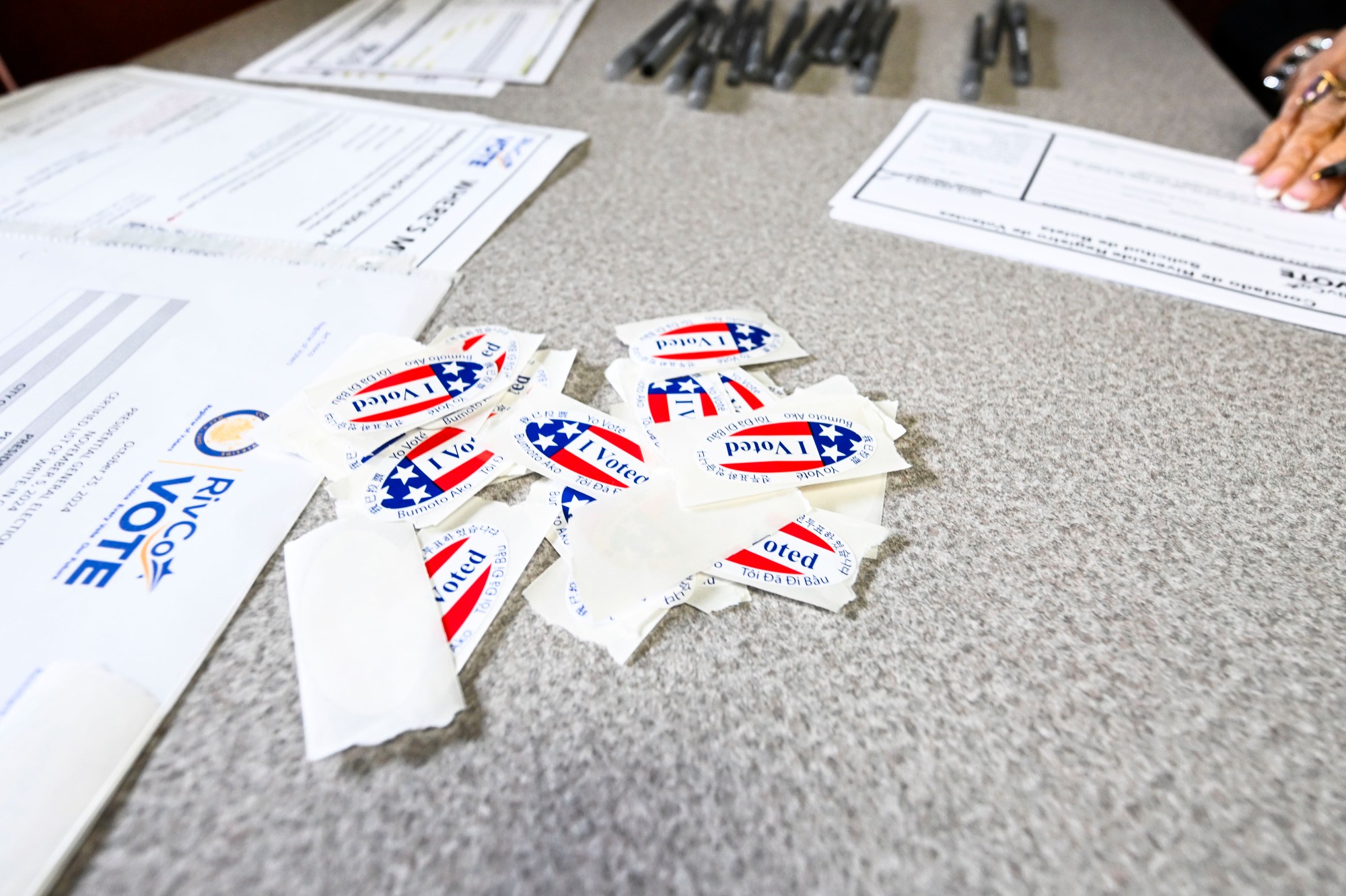 “I Voted” stickers sit on a desk at the Corona Public Library as voters casts ballots on Election Day, Tuesday, Nov. 5, 2024. (Photo by Anjali Sharif-Paul, The Sun/SCNG)
