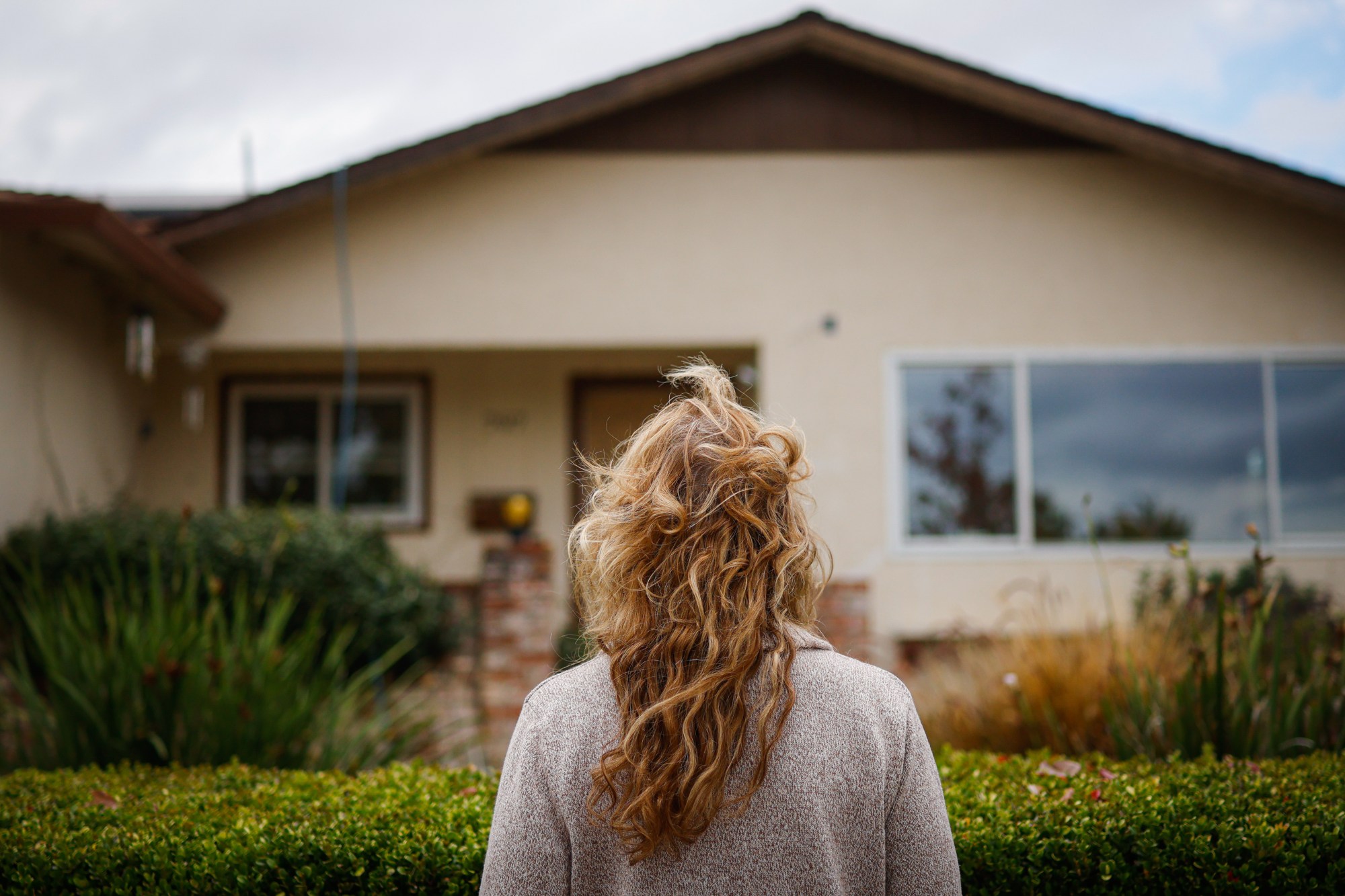 Sheri Duffy looks at her childhood home at in Sunnyvale, Calif., on Wednesday, Nov. 12, 2025. (Shae Hammond/Bay Area News Group)
